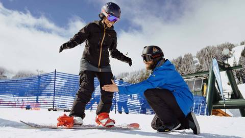 Snowboarder getting buckled